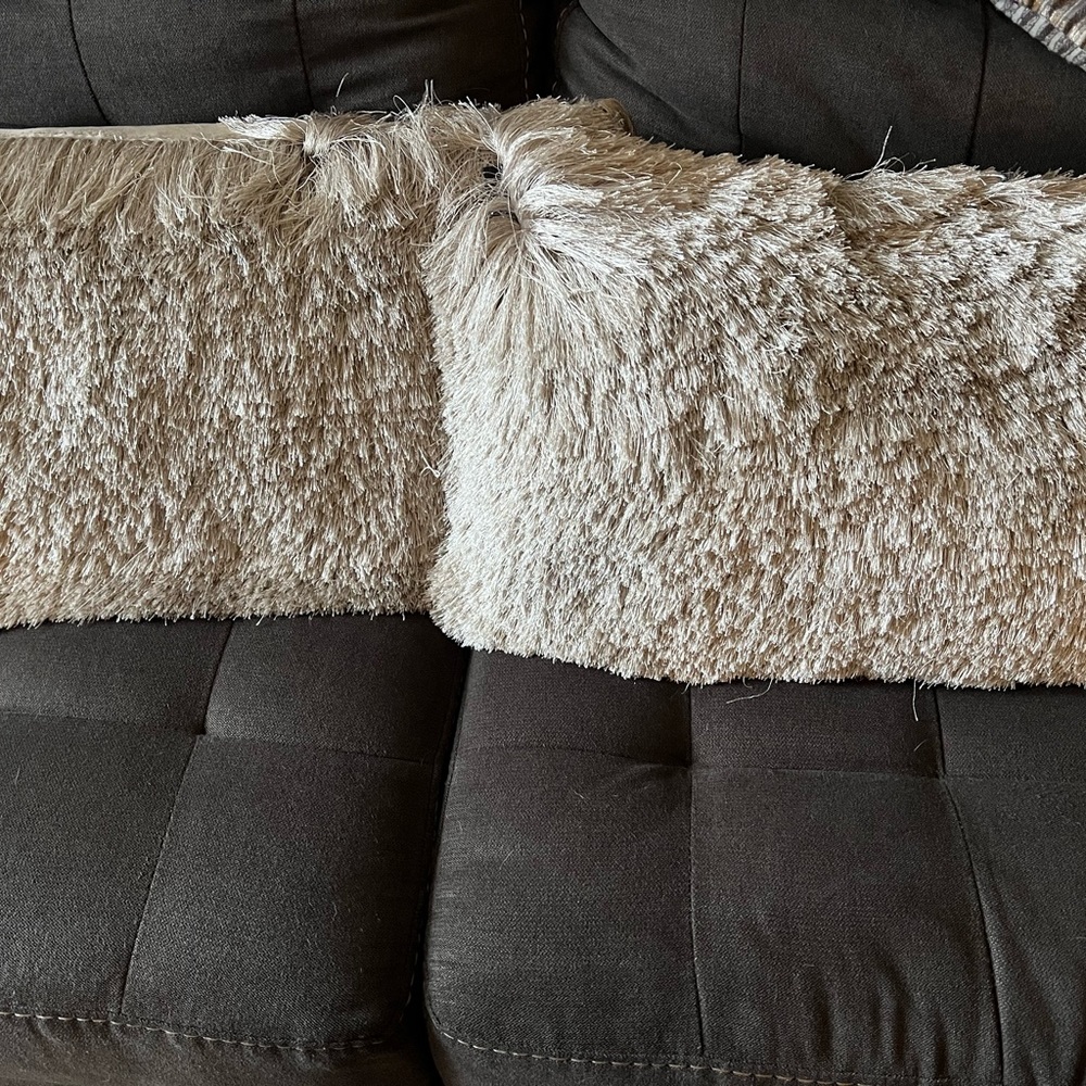 2 silver shaggy pillows with silver sparkles.